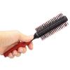 Woman Blow Drying Hair Brush