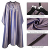 Hair cutting cape showing convenient side openings for client phone access